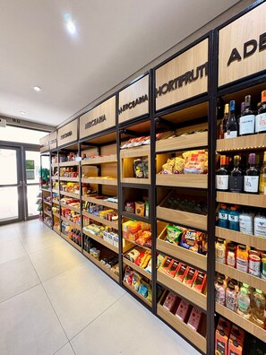 A grocery store aisle with shelves stocked with snacks, beverages, and packaged goods. - Z Pinheiros  (São Paulo)