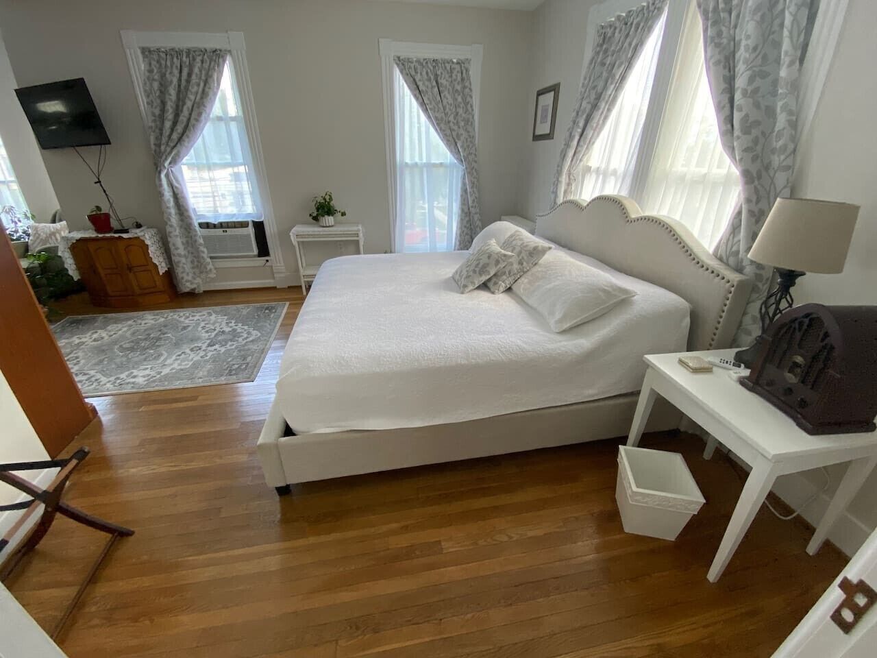 A bedroom with a bed, bedside table, and a lamp.