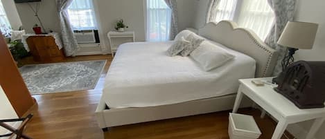 A bedroom with a bed, bedside table, and a lamp.