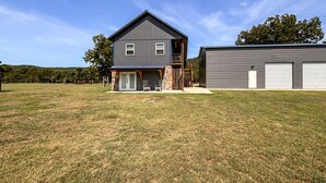 A two-story house with a front porch and a garage. - *NEW* River Valley Retreat ~ directly on White River (Mountain View)