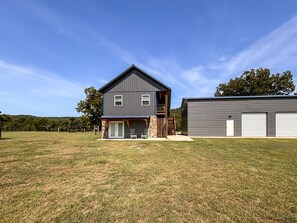 A two-story house with a front porch and a garage. - *NEW* River Valley Retreat ~ directly on White River (Mountain View)
