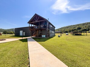 A two-story building with a balcony and a covered outdoor area. - *NEW* River Valley Retreat ~ directly on White River (Mountain View)