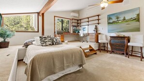 A bedroom with a bed, desk, chairs, and a painting. - Palisades Villa | 360 Views, Hot Tub, Mid-Century (Sedona)