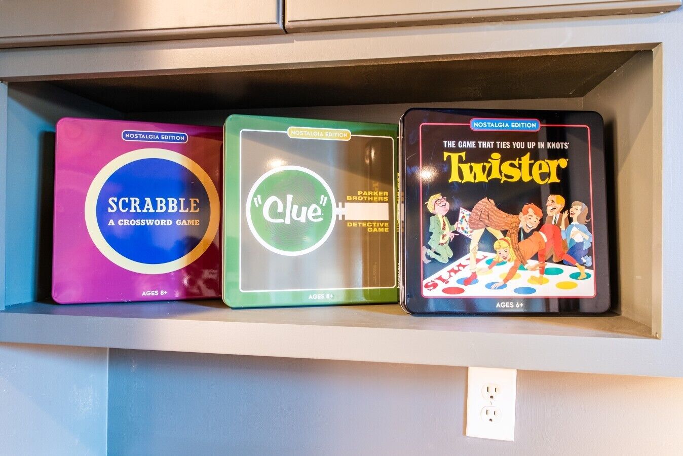 Three board games on a shelf.