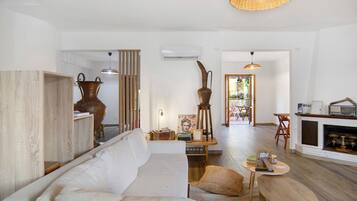 A modern living room with a sofa, a coffee table, and a fireplace.