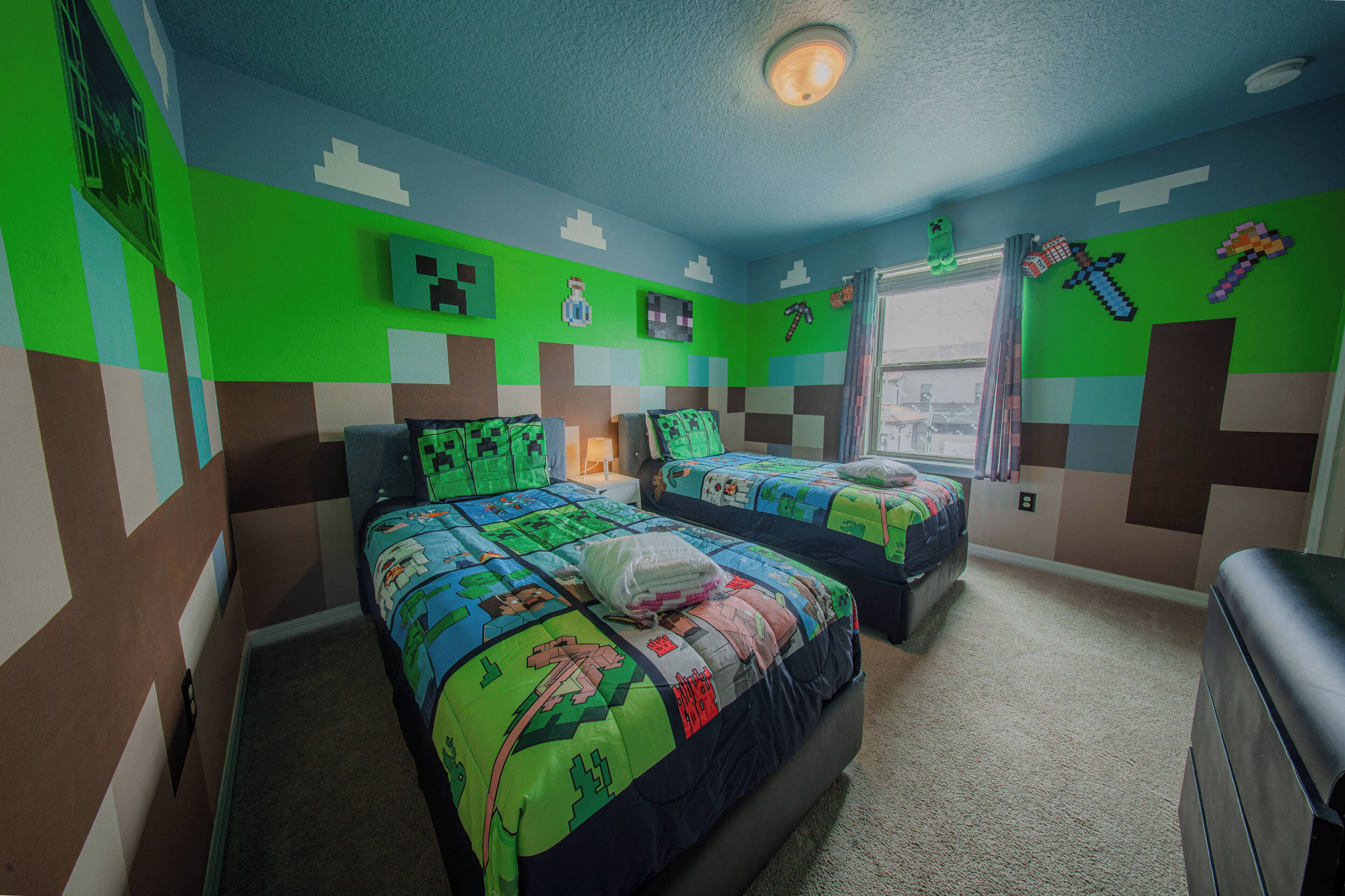Une chambre avec deux lits, une fenêtre et des décorations murales sur le thème de Minecraft.