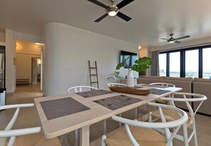 A modern dining area with a table, chairs, and ceiling fans. - Marbella lane - Stylish Private Villa OceanViews (Cabo San Lucas)