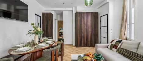 A modern living space with a dining area, a sofa, and a coffee table.