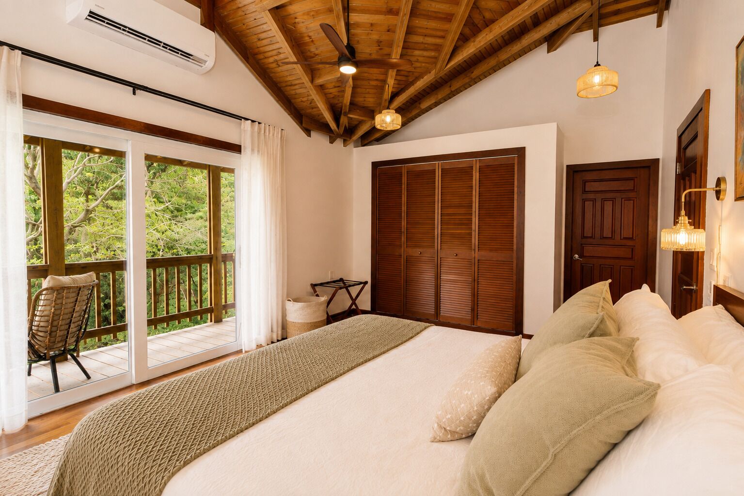 A bedroom with a bed, a wooden ceiling, a window with curtains, and a door.
