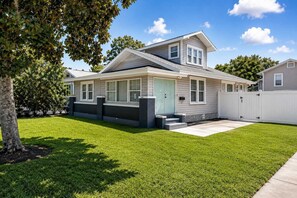 A two-story house with a front porch, a garage, and a well-maintained lawn. - 3BR Home | Prime Lake Hollingsworth | Dog Friendly (Lakeland)