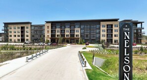 A multi-story residential building with a prominent entrance and a sign reading 'THE NELSON'. - Studio-Style 1BR Retreat at The Nelson (Austin)