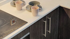 A kitchen with a white countertop, a coffee maker, and a box on the counter. - Beautiful Dubai Marina View 1BR - Walk to Beach & Metro (Dubai)
