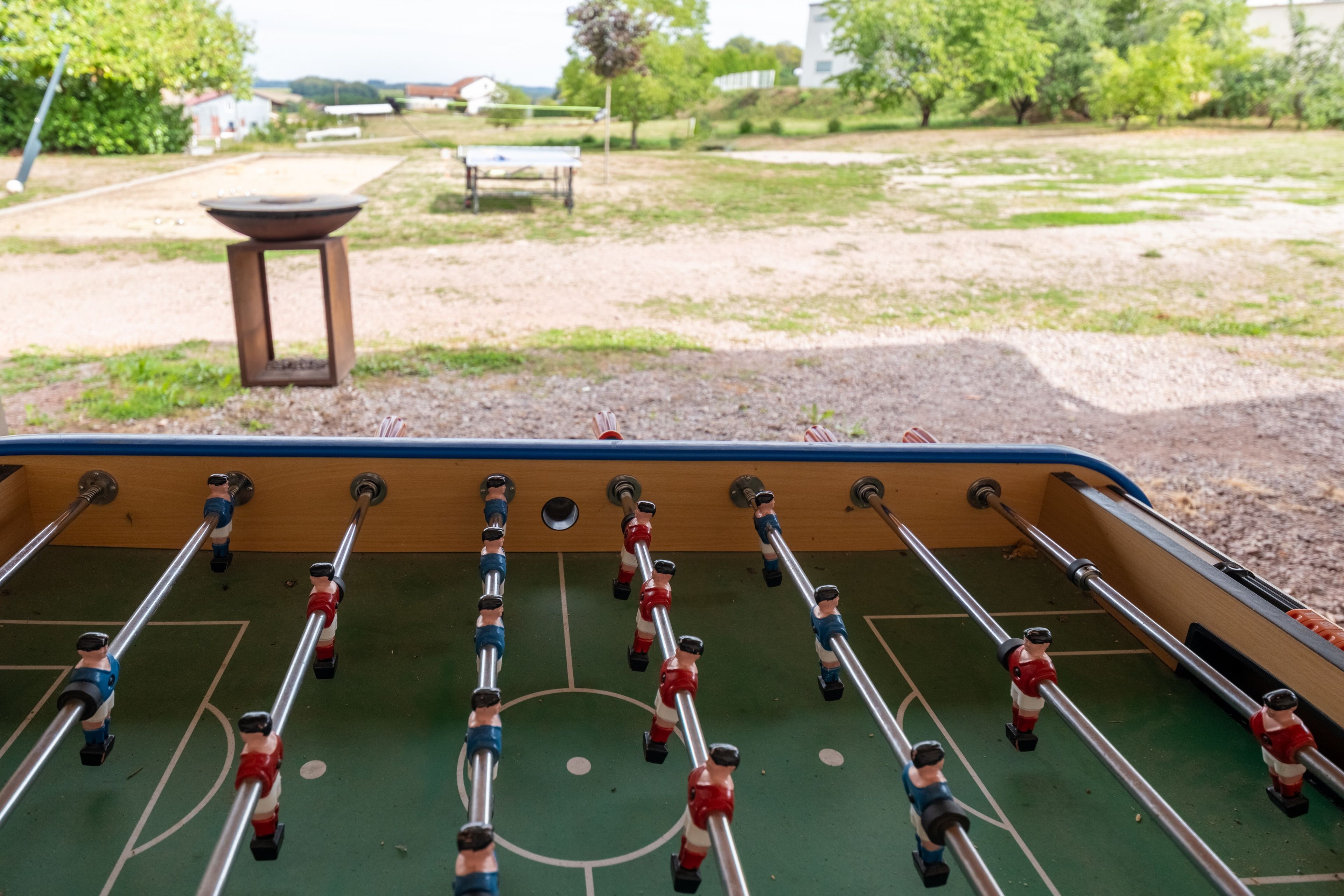A foosball table with players in red and blue uniforms.