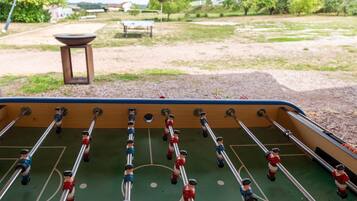 A foosball table with players in red and blue uniforms.