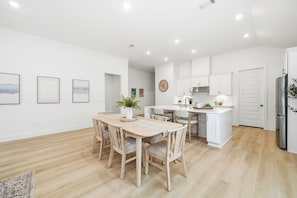 A modern kitchen with white cabinets, a central island, and a built-in oven. - A/C Game room, Golf Cart,  Autism Friendly (Port St Joe)