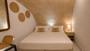 A bedroom with a bed, a nightstand, a lamp, a chair, and a table. - Just a short walk from the Cathedral, the Swabian Castle, the harbor, and downtown. (Trani)