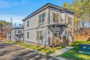 A two-story residential building with a front porch and a garage. - Smokies Modern Cabin Fireplace, Fire Pit, Games! (Pigeon Forge)