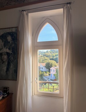 A room with a window featuring a view of a hillside with buildings. - Adorable studio with AC in charming La Croix-Valmer (La Croix-Valmer)