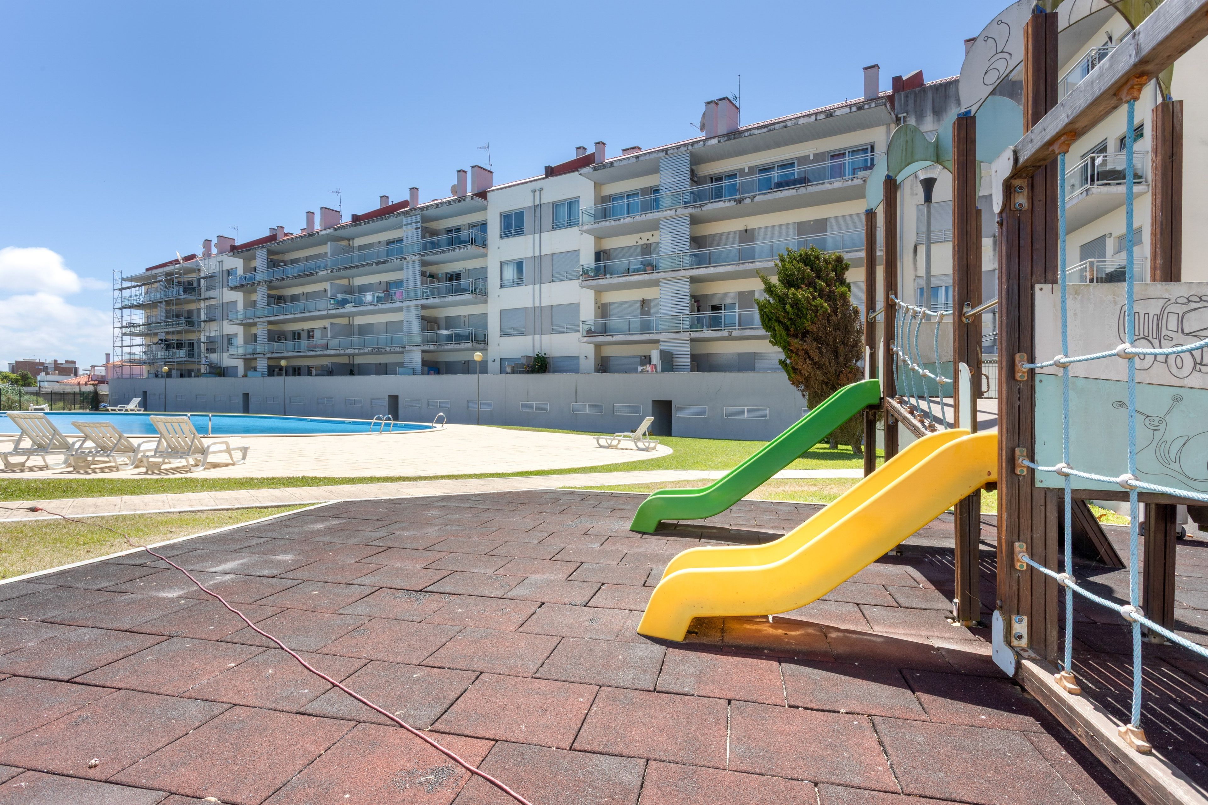 A playground with slides and a swimming pool.