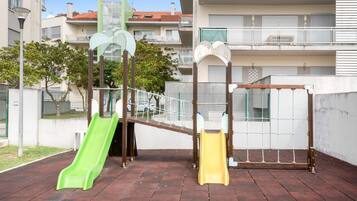 Un parque infantil con dos toboganes y una estructura para escalar.