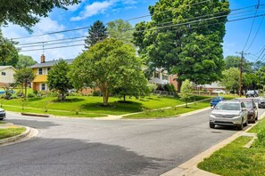 A residential street with houses, a car, and trees. - Silver Spring Retreat Near DC | Pet Friendly Yard (Silver Spring)