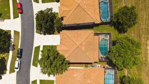 A residential area with two houses, each with a swimming pool and a garage. - Wh2596 - 6BR House at Windsor Hills Resort (Kissimmee)
