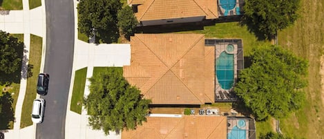 A residential area with two houses, each with a swimming pool and a garage.