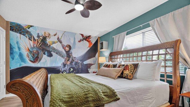 A bedroom with a bed, a ceiling fan, a window with curtains, and a wall mural. - Wh2596 - 6BR House at Windsor Hills Resort (Kissimmee)