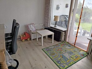 A room with a white table, a child's toy, a radiator, and a view through a glass door. - 6 Person Holiday Home in Nykobing M (Nykobing Mors)