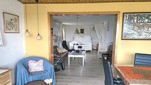 A room with a bed, a desk, a chair, a sofa, and a dining table. - 6 Person Holiday Home in Nykobing M (Nykobing Mors)