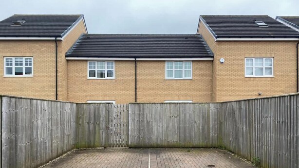 A two-story building with a brick facade, multiple windows, and a wooden fence in the foreground. - Modern Stockton Retreat Sleeps 6 by Stay With Us (Stockton-on-Tees)