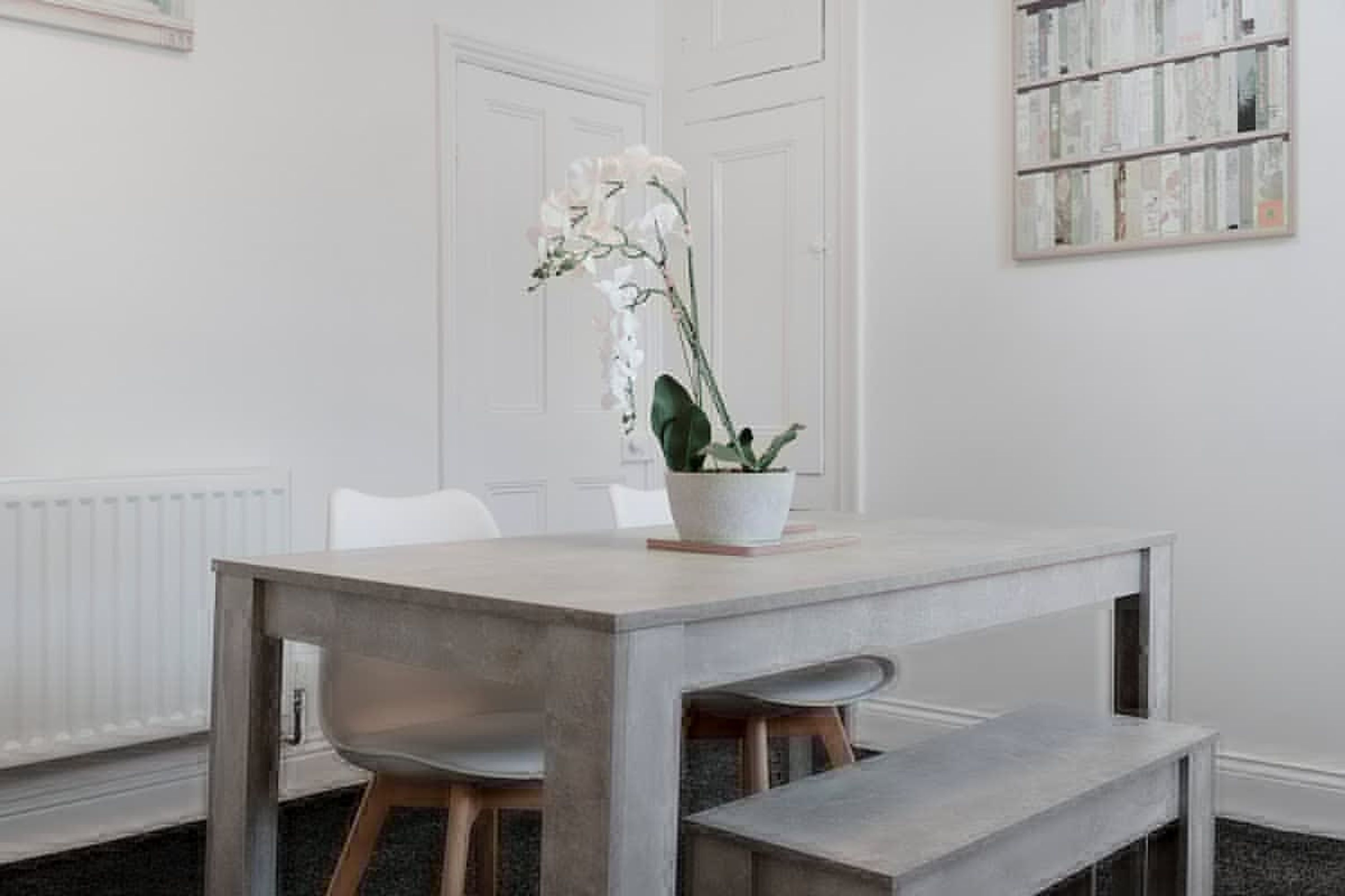 A dining area with a table, chairs, and a bench.