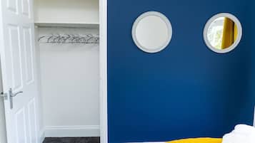 A room with a blue wall, a white door, and a yellow chair.