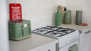 A kitchen with a gas stove, a toaster, and a fire blanket on the counter. - Elegant 4BR Houghton St Sleeps 7 by Stay With Us (Hartlepool)