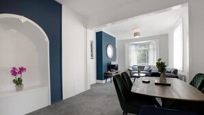 A modern living room with a dining area, a sofa set, and a television. - 3 Bed in Sunderland With Free Wifi (Sunderland)
