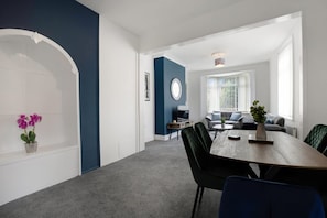 A modern living room with a dining area, a sofa set, and a television. - 3 Bed in Sunderland With Free Wifi (Sunderland)