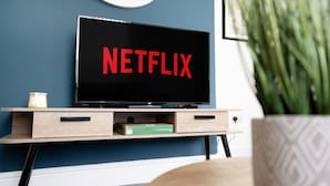 A television on a wooden stand with the Netflix logo on the screen. - 3 Bed in Sunderland With Free Wifi (Sunderland)