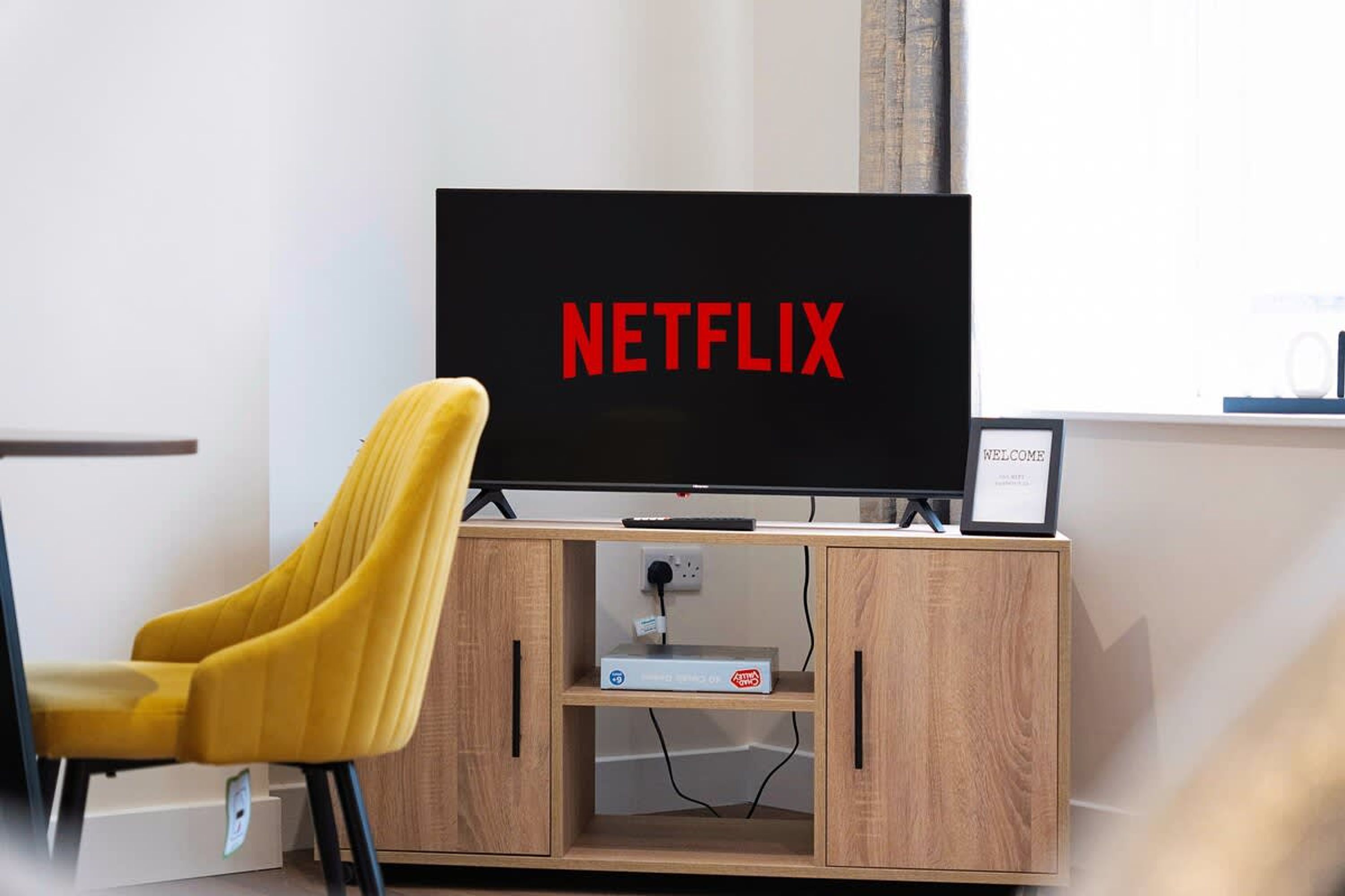 A television with the Netflix logo on a stand in a room.