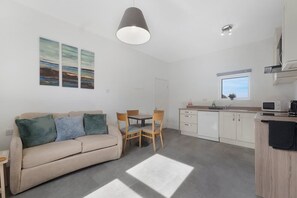 A modern, well-lit living room with a sofa, chairs, and artwork on the wall. - 1 Bedroom With Sofa Bed Near Train Station (Darlington)