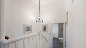 A staircase with white balusters leading to a bathroom with a glass shower enclosure. - 3 Bedroom in Haughton Road With Free Wifi (Darlington)