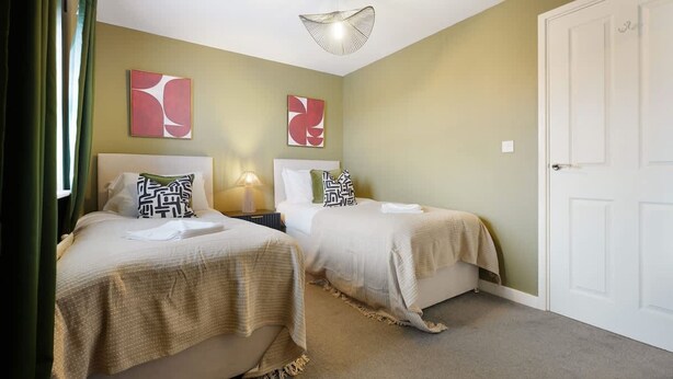 A hotel room with two beds, a door, and abstract wall art. - Teesside 3BR Family Retreat Sleeps 5 by Stay With Us (Stockton-on-Tees)