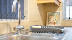 A kitchen with a stainless steel sink, a toaster, and a window with a view of the outside. - 2BR in Dundee Free Wifi and Indoor Fireplace (Darlington)