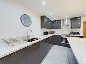 A modern kitchen with a built-in oven, a microwave, and a toaster. - Charming 3-bedroom Home in the Heart of Stanhope (Bishop Auckland)