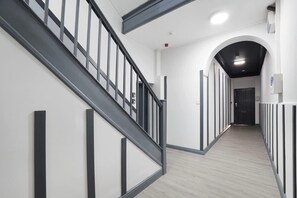 A modern interior with a staircase, a hallway, and a door. - 4 Bedroom With Private Parking and Wifi (Stockton-on-Tees)
