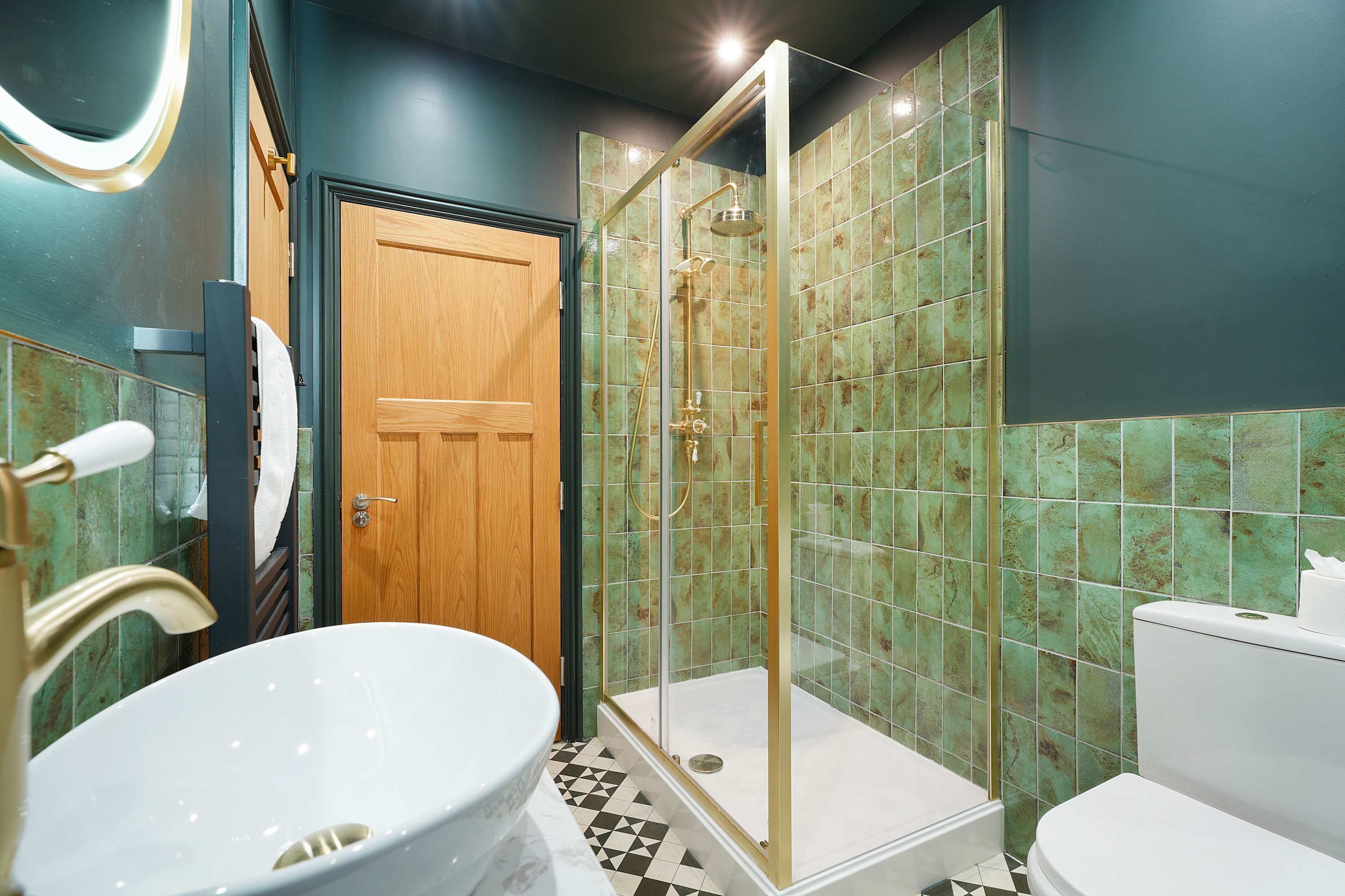 A bathroom with a freestanding bathtub, a shower enclosure, and a toilet.