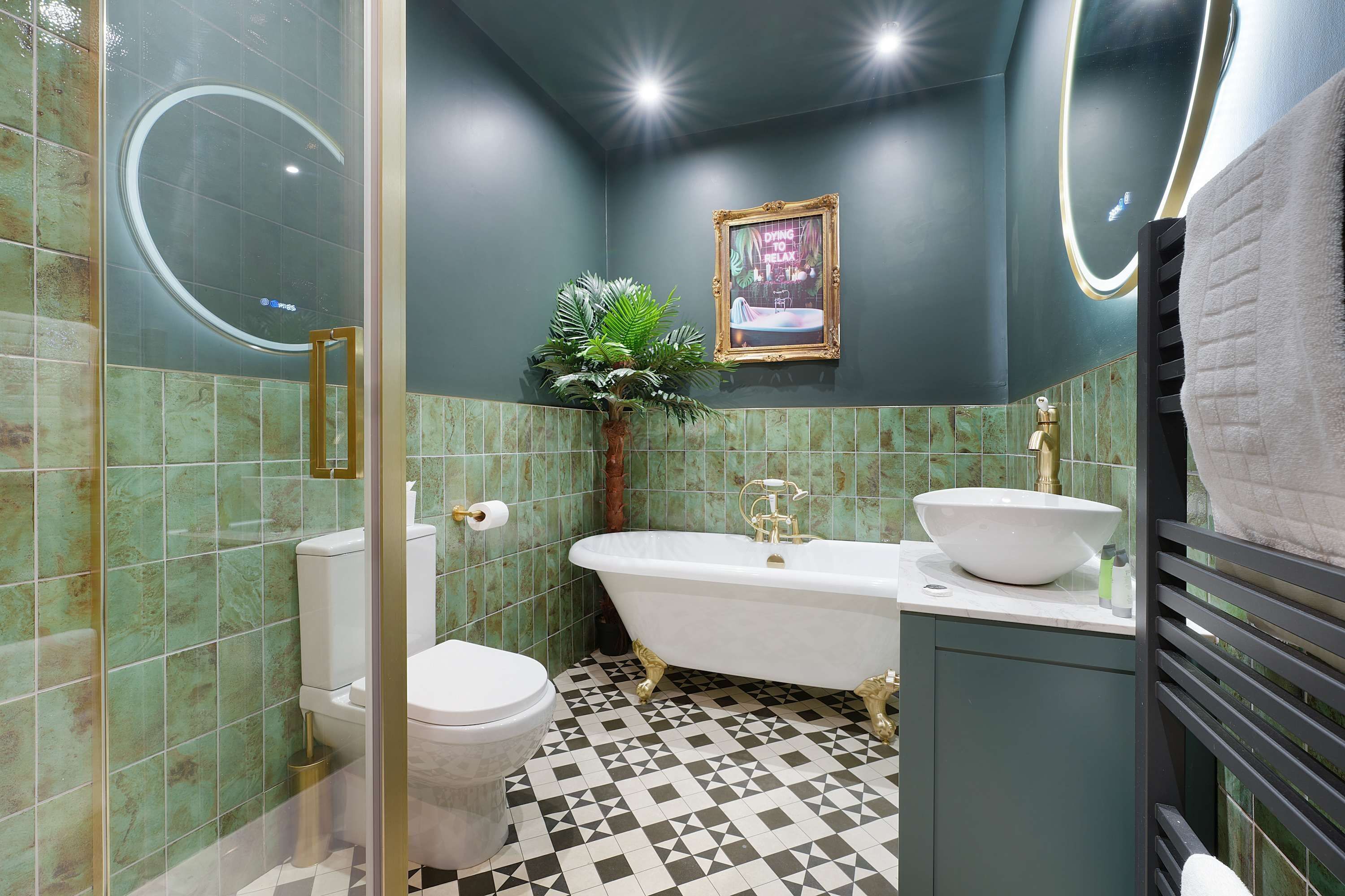 A bathroom with a bathtub, two sinks, a toilet, and a shower.