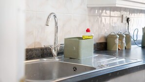 A kitchen with a stainless steel sink, a marble backsplash, and a green container on the counter. - 4BR in Stafford Place Sleeps 7 Wifi Free Parking (Peterlee)