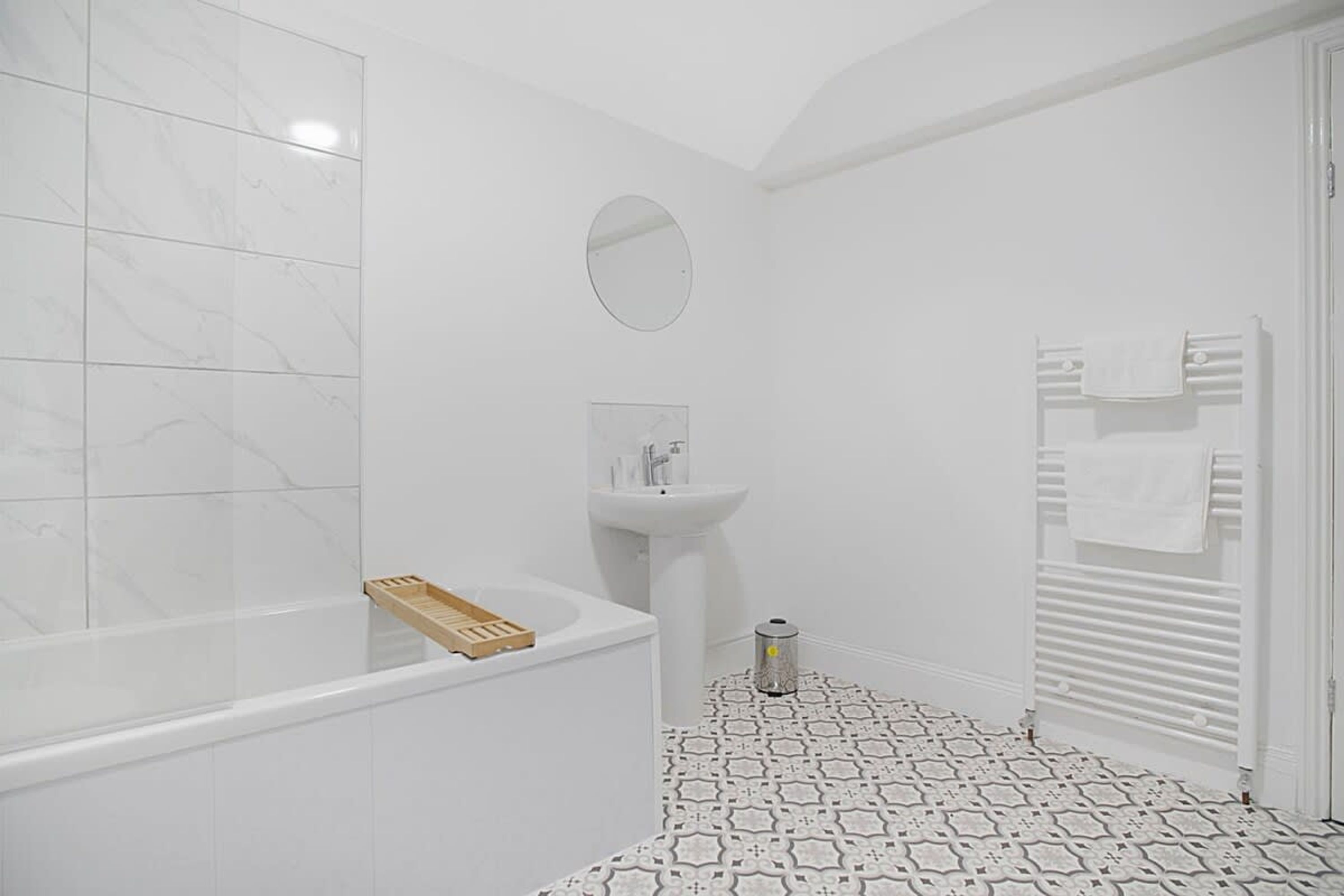 A bathroom with a bathtub, a sink, and a toilet.