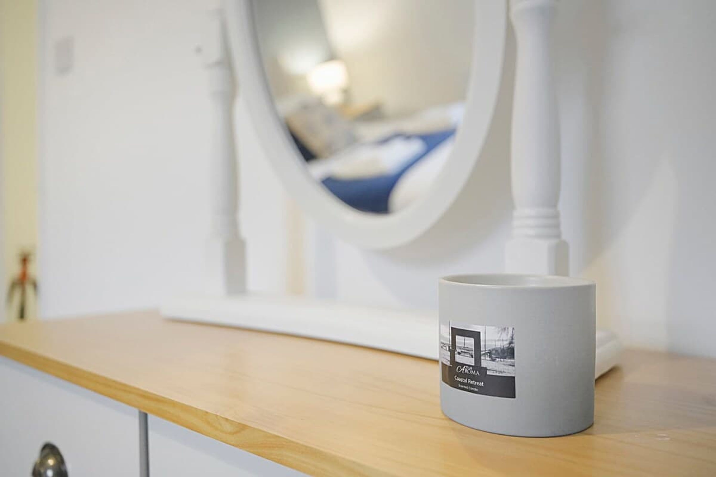 A white mug with a black label on a wooden surface.