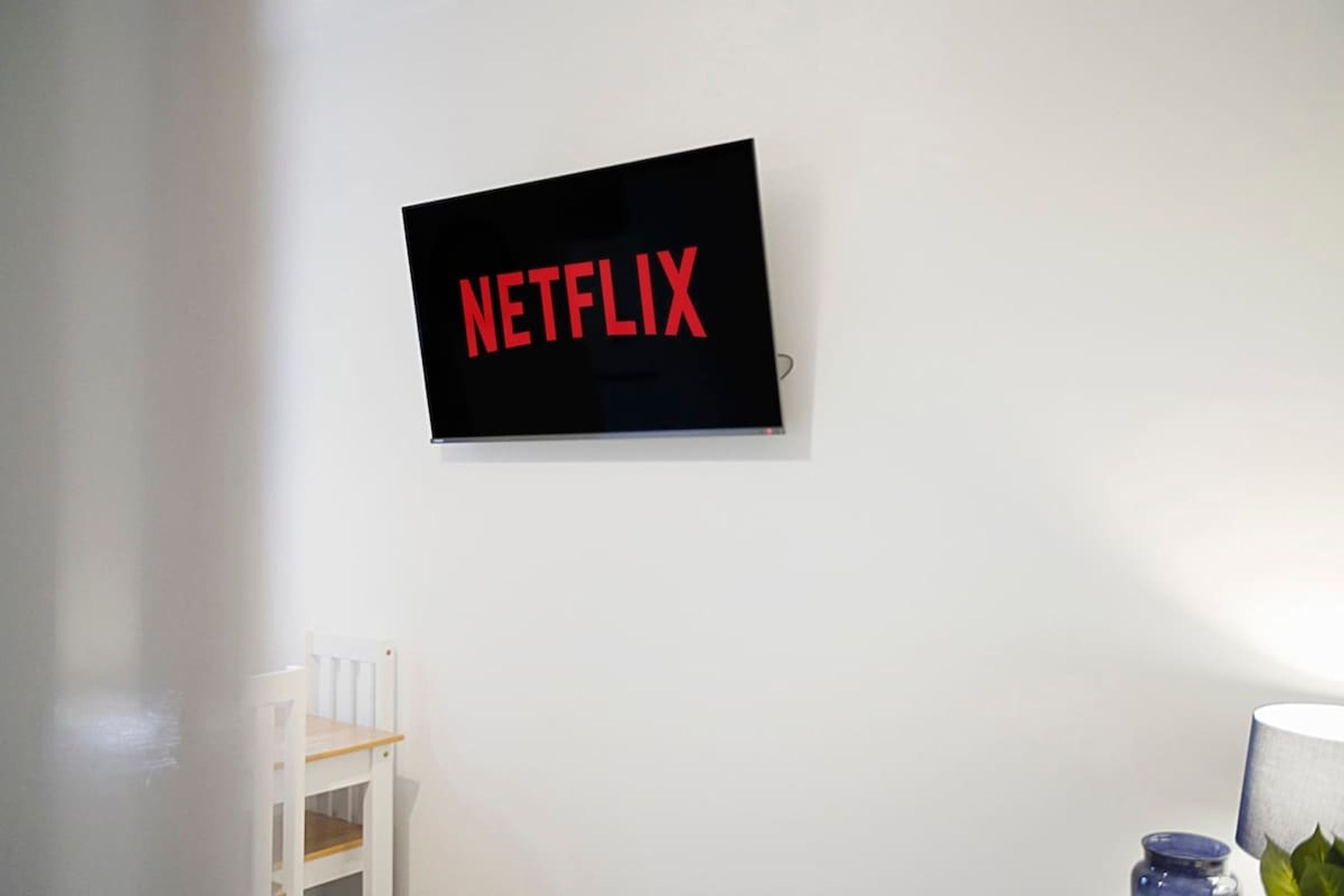 A wall-mounted television with the word 'NETFLIX' in red letters.